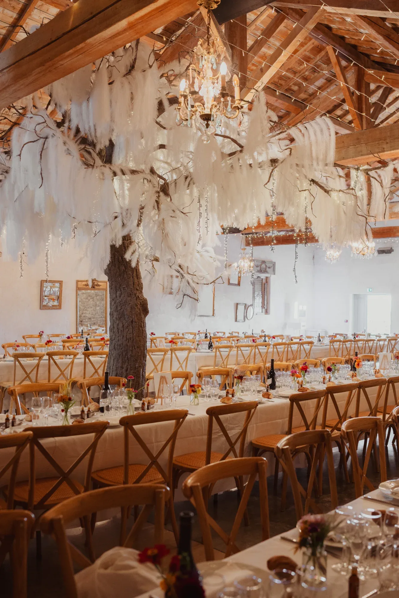 A decorated and illuminated barn for a wedding reception