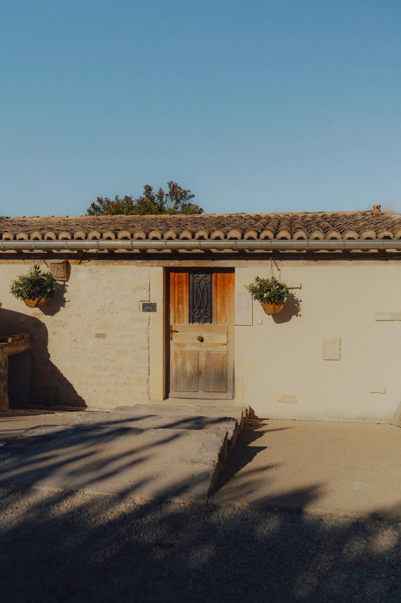 Facade of a stone farmhouse on the estate with its wooden door